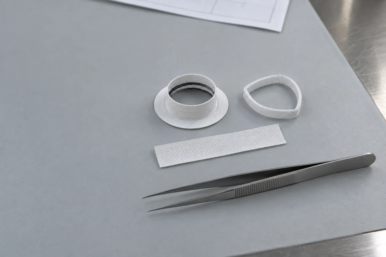 woven textile cuff, contoured ring, drawing and precision tools