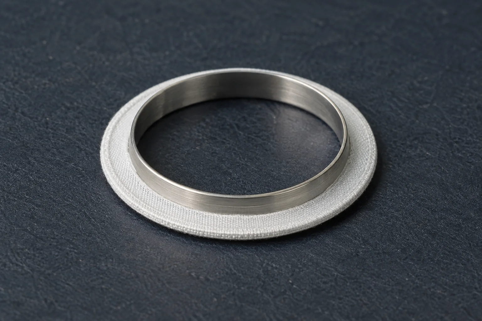 Fine white annular textile cuff around a circular metal support